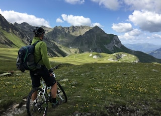 man riding bicycle on top of mountain