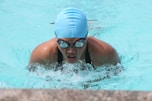 person swim on inground pool