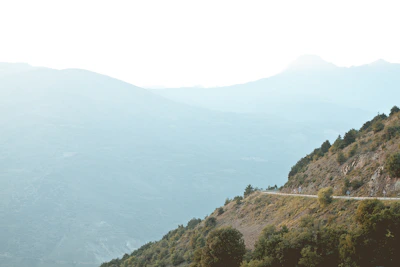 A serene mountain landscape in Sikkim with a winding road and lush greenery.