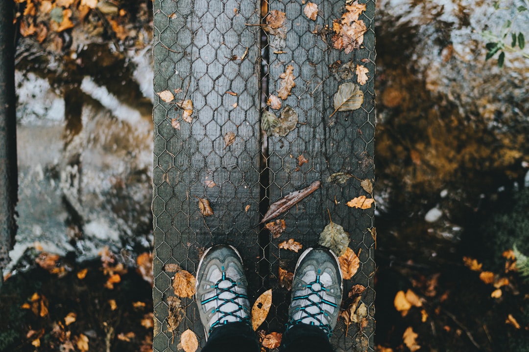 person showing pair of gray shoes