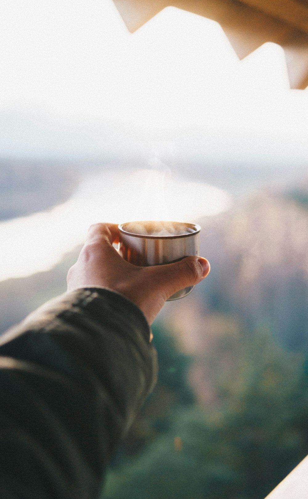 person holding drinking cup