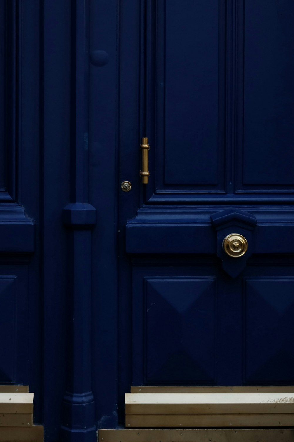 a blue door with a gold handle on it