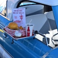 hamburger, soda, and ice cream set next to pick-up