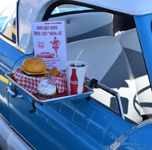 hamburger, soda, and ice cream set next to pick-up