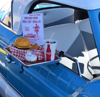 hamburger, soda, and ice cream set next to pick-up