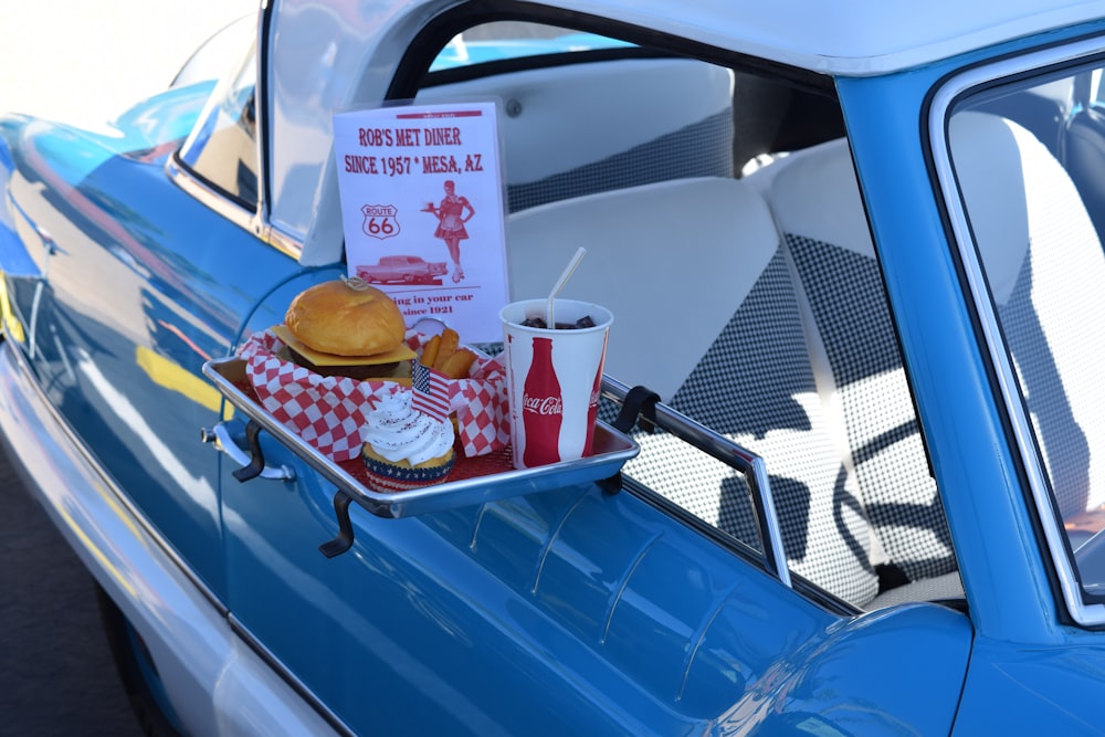 hamburger, soda, and ice cream set next to pick-up