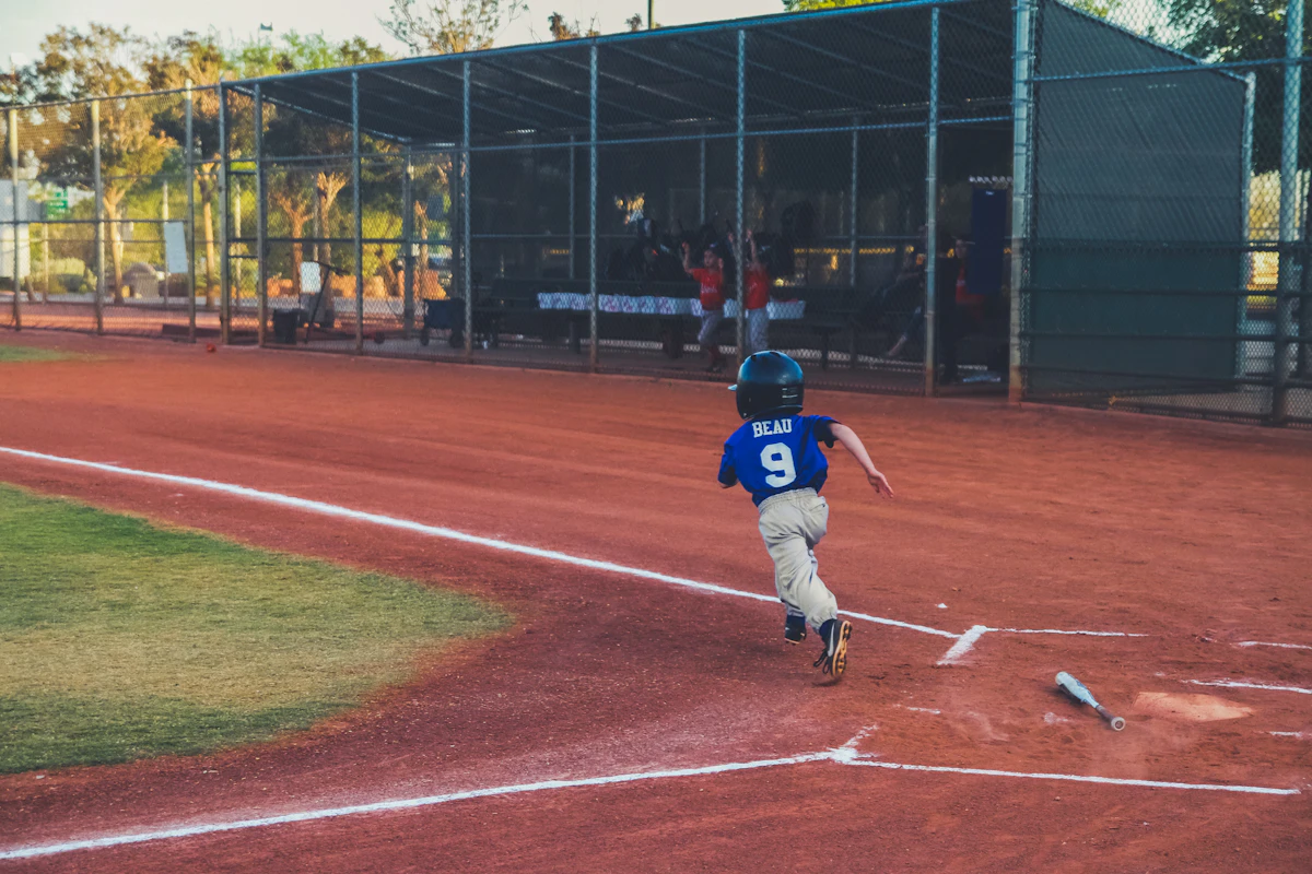 Young baseball player running the bases