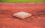 square brown concrete baseball base on soil