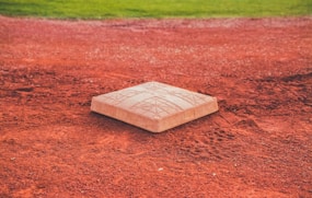 square brown concrete baseball base on soil