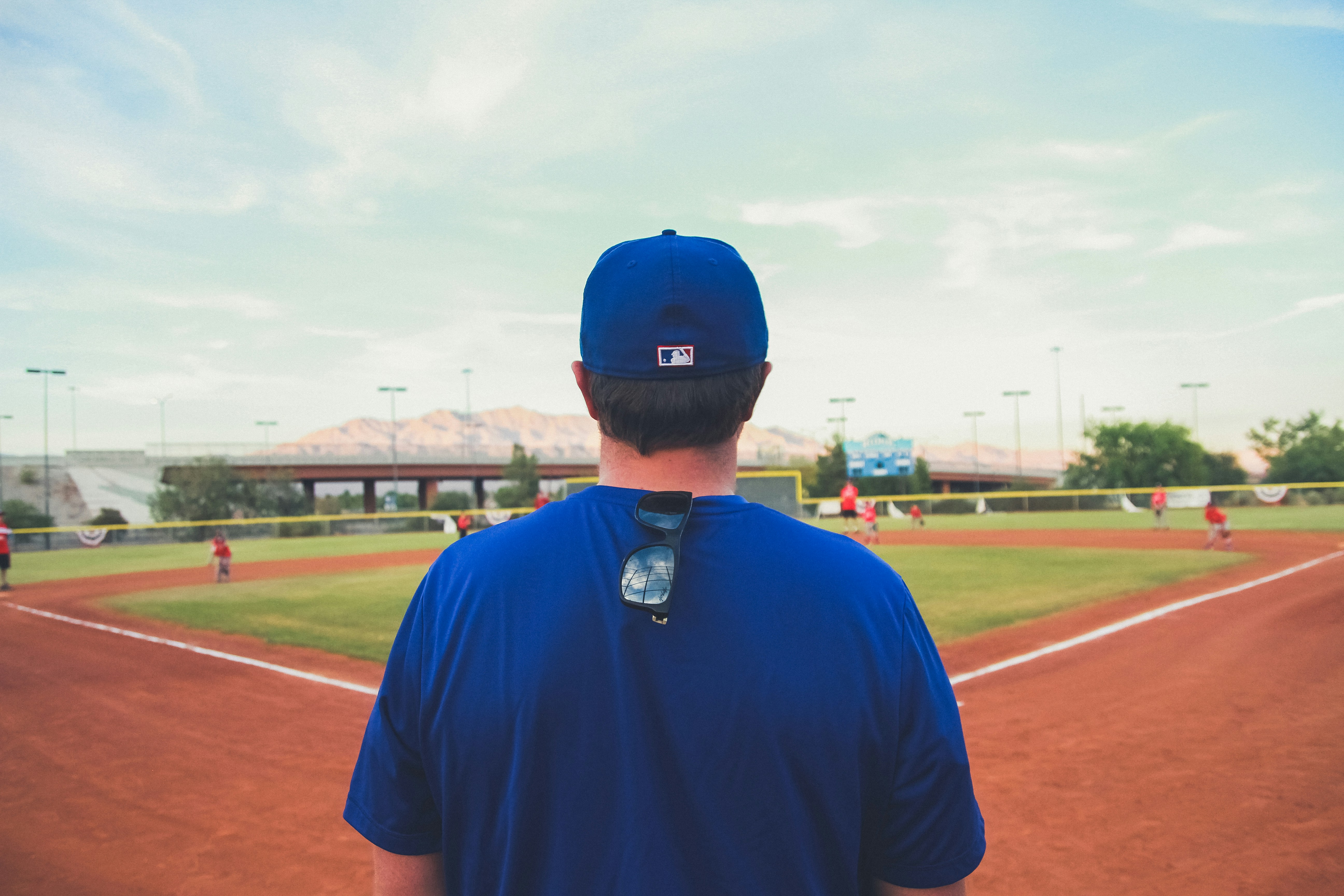 man overlooking baseball field