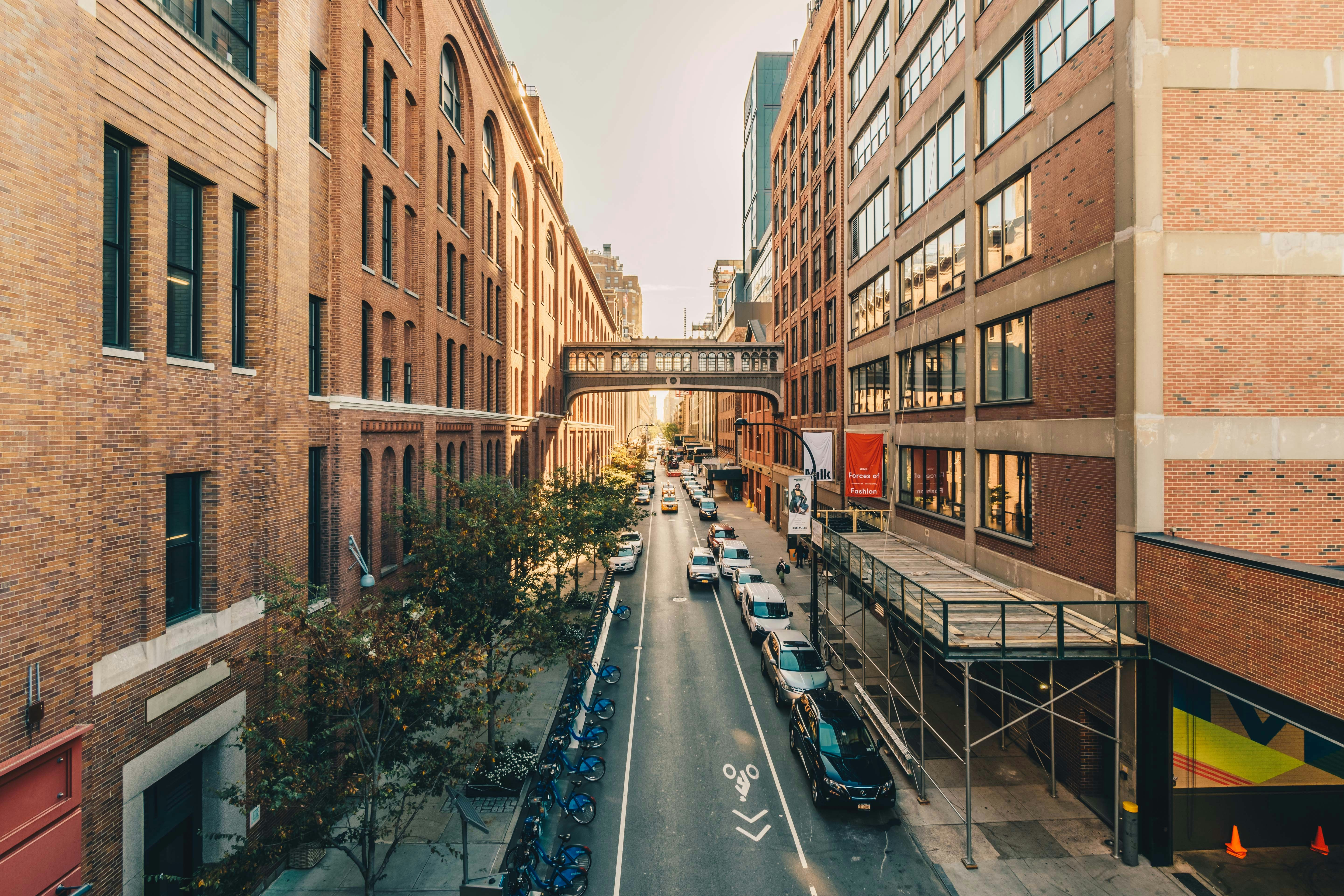 assorted cars parked in middle of buildings