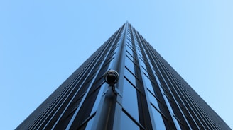 Wide-angle view of a high-rise building with multiple security cameras.