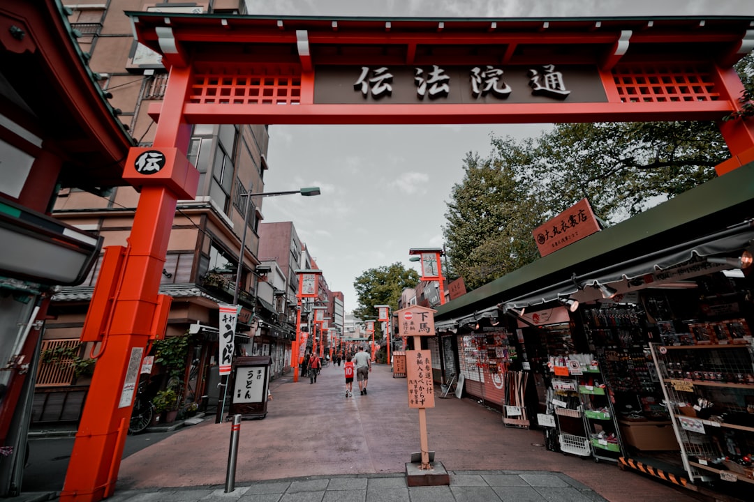 Kanji script text arch front of gray concrete pavement