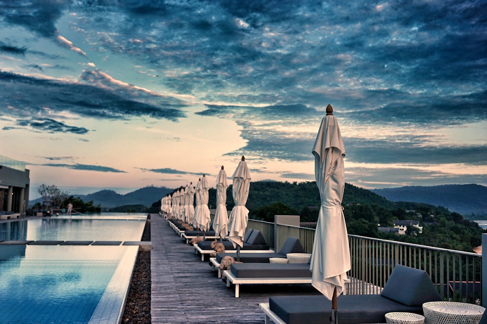 row of folded patio umbrella near pool