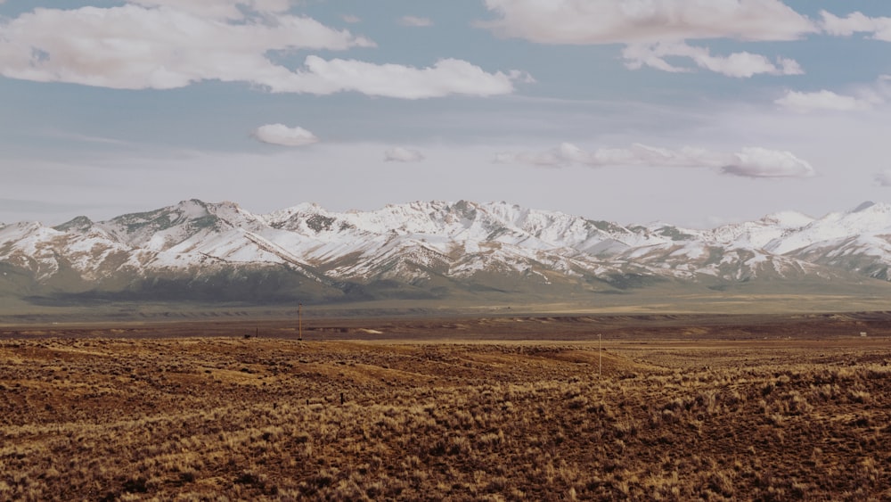 mountains covered with snow under gray clouds