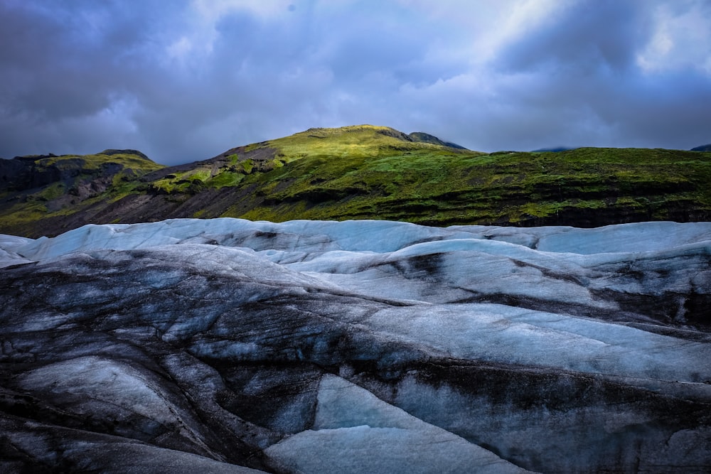 green mountain under white clouds