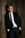 man standing beside wood