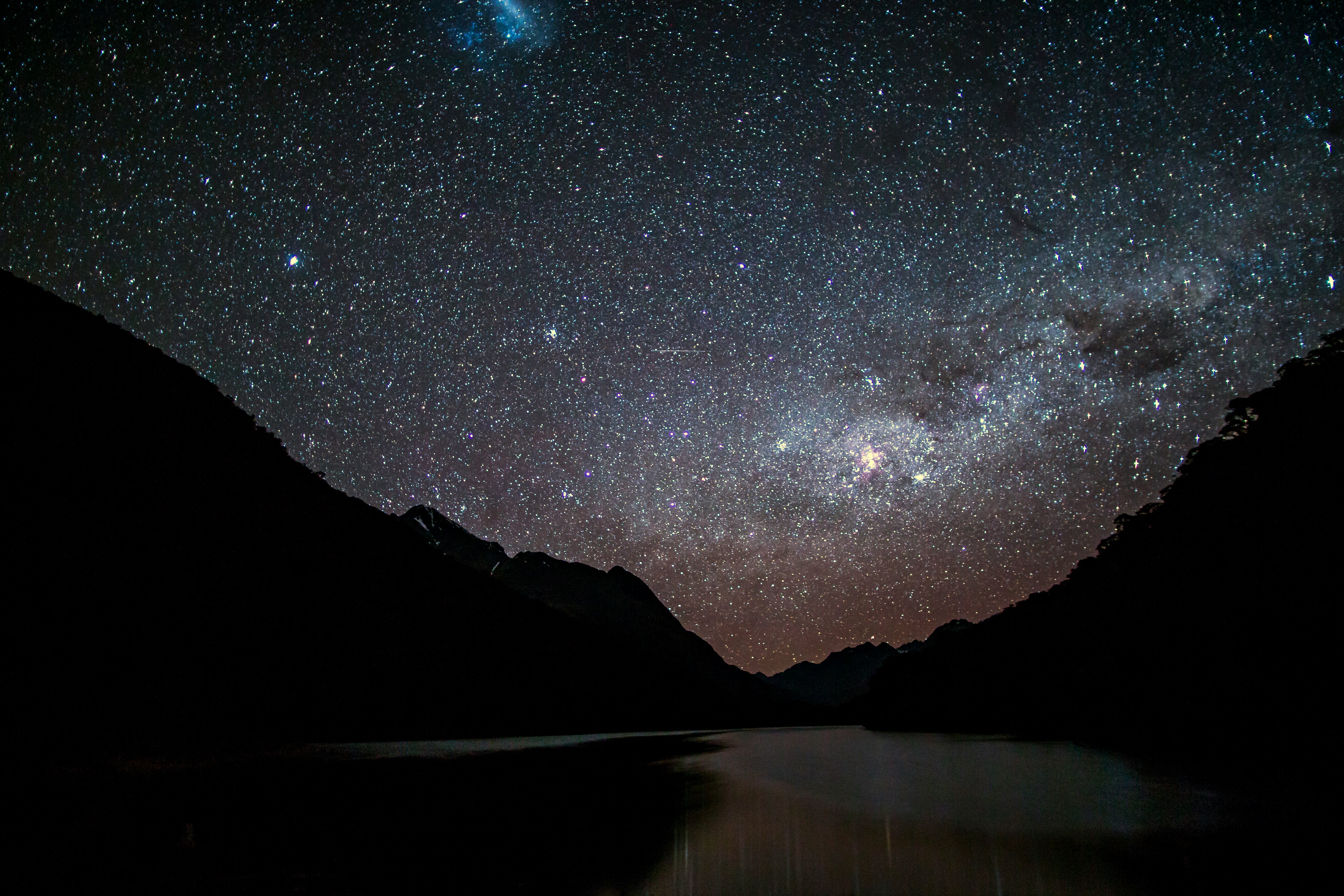 silhouette photo of mountain near body of water