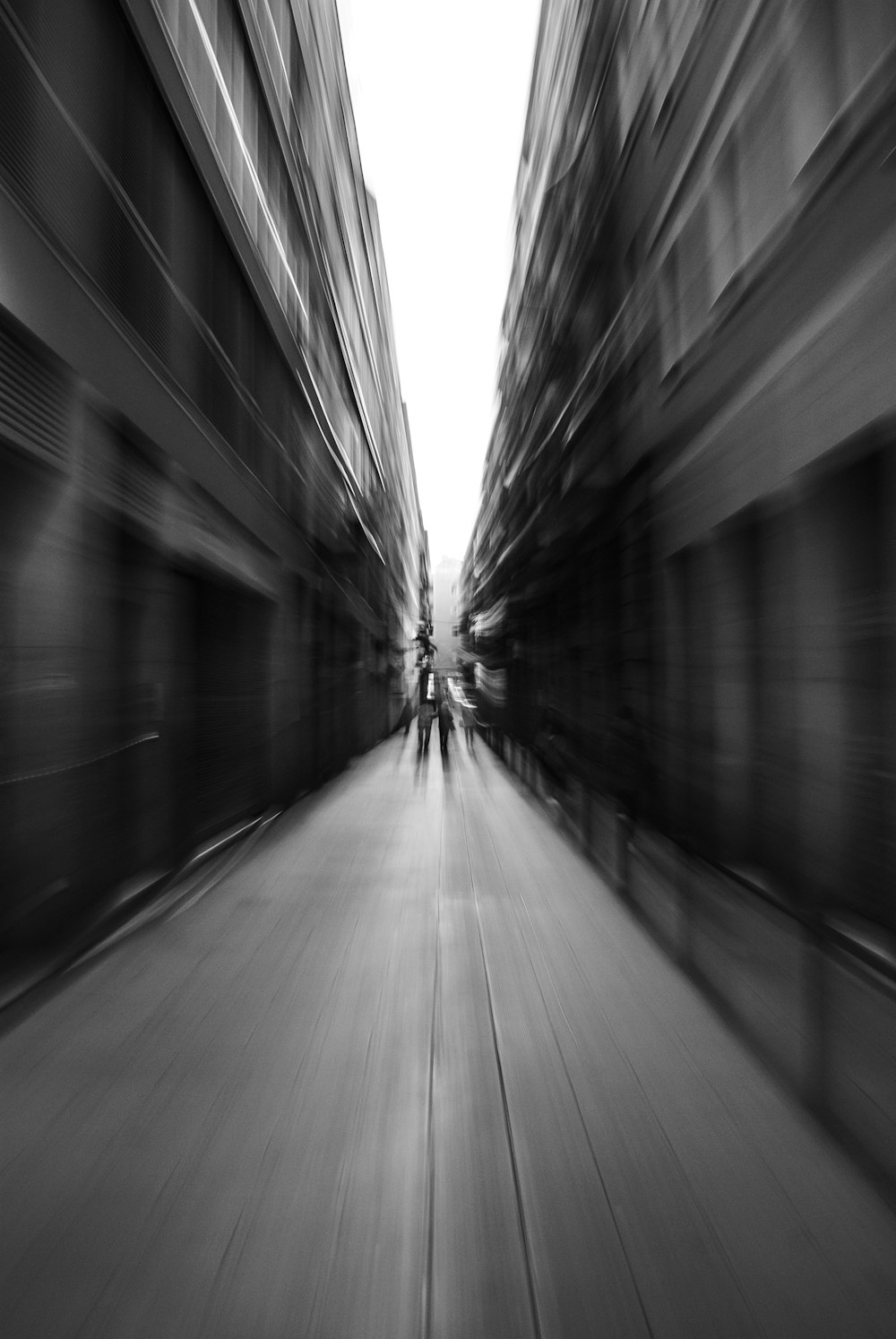 motion photography of person walking between building