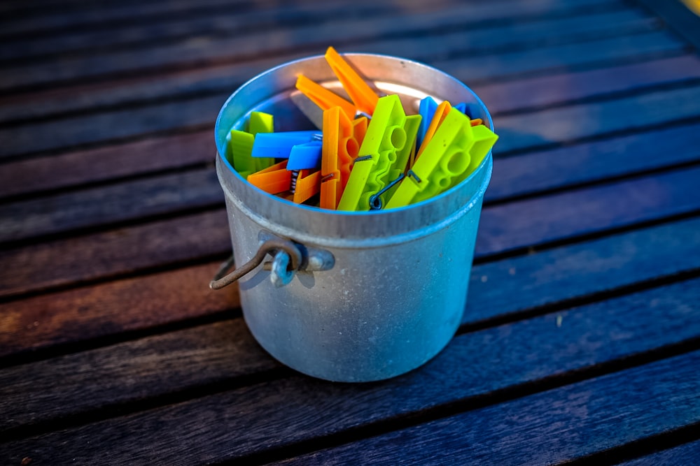 grey bucket on brown wooden surface