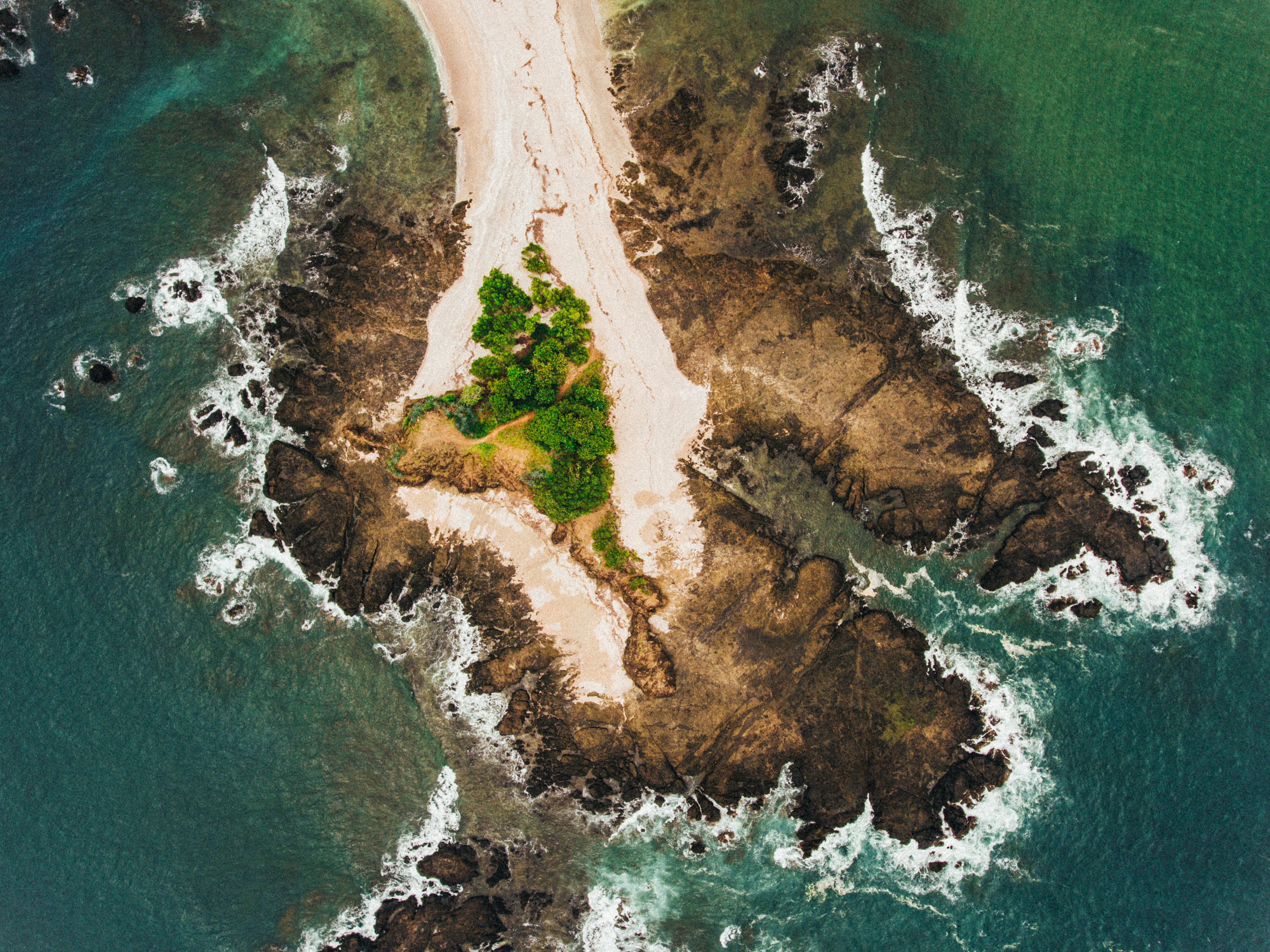aerial view photography of island, This snapshot was taken from my drone after getting lost on one of the bad backroads of costa rica. After spotting this empty and deserted beach we spend the rest of the day enjoying the sun and sea.