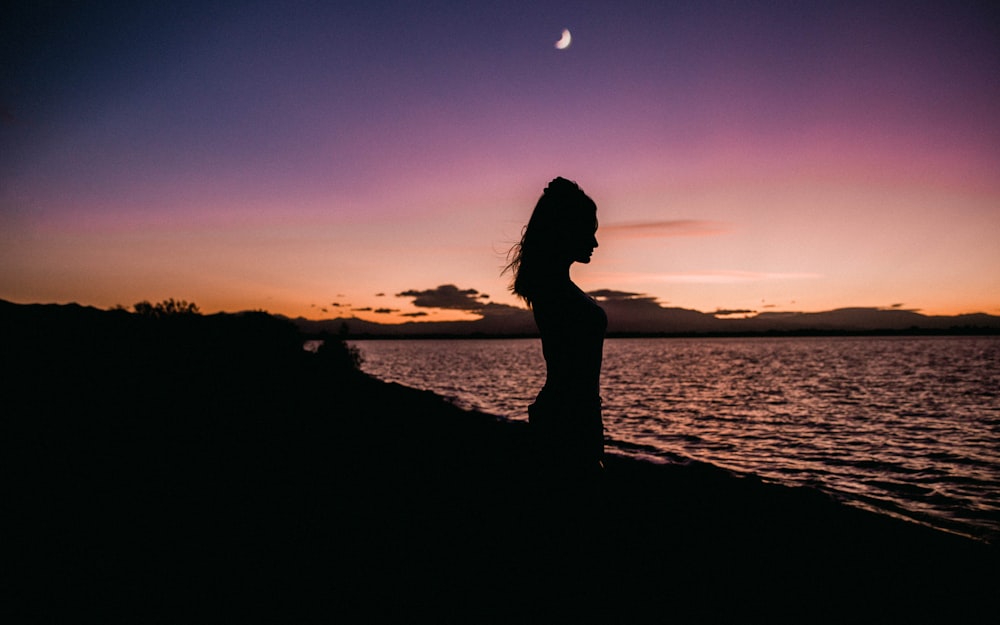 silhouette of woman near of water