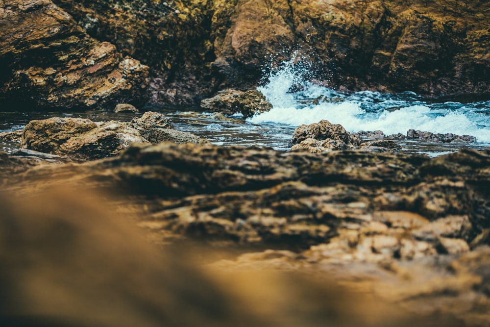 landscape photography of rock structure near body of water