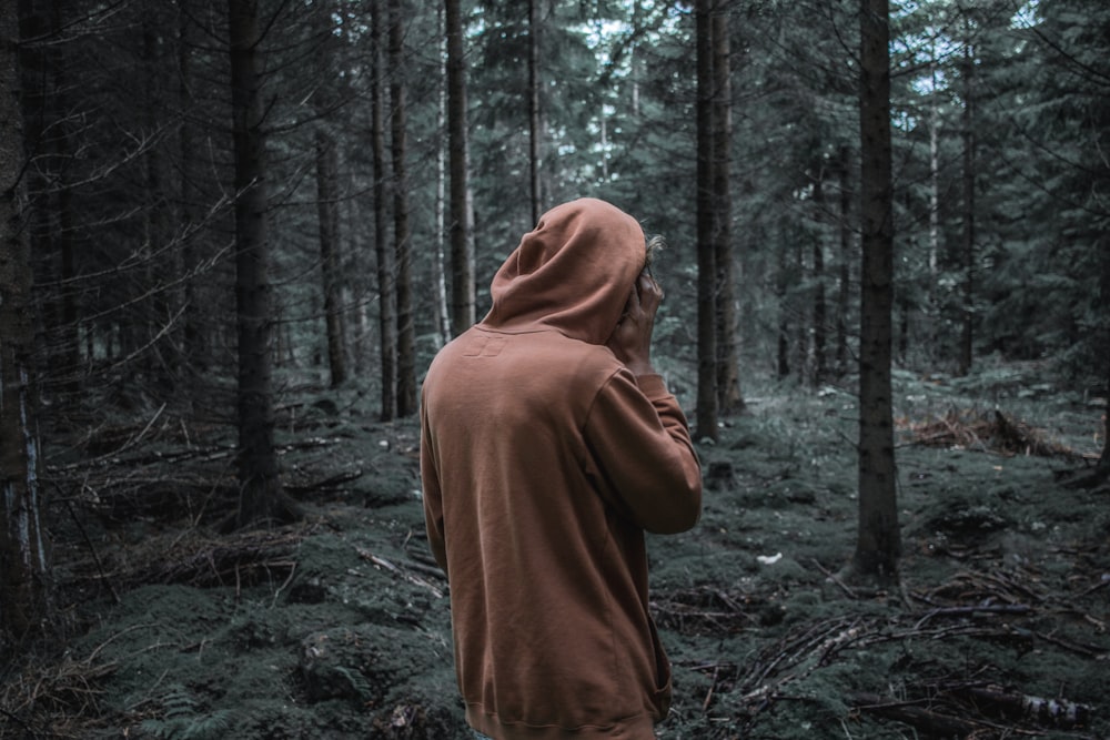 person standing in front of trees