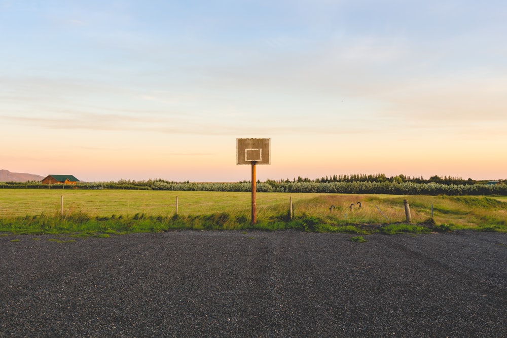 photography of orange basketball ring on gray sand