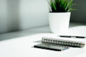pen, notebook, and smartphone on table