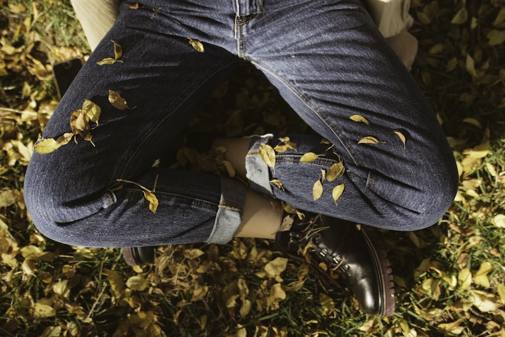 sitting man in blue jeans