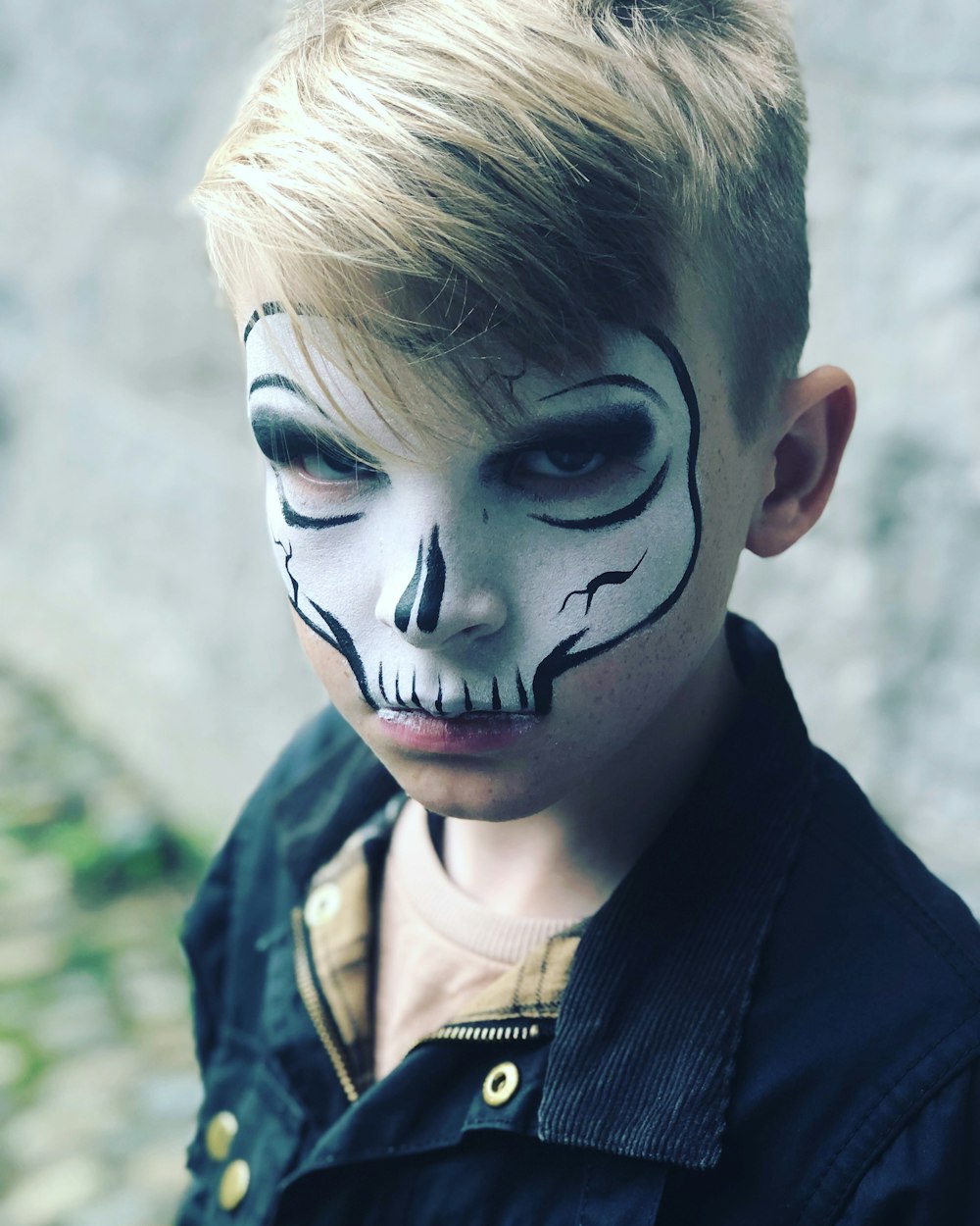 child with skull face painting