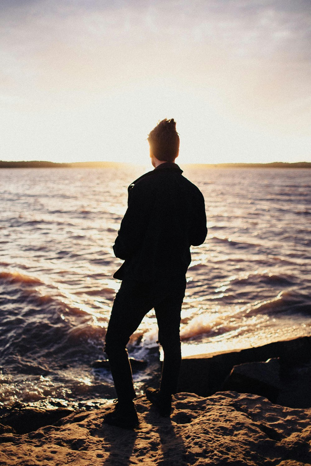 man standing near seashore