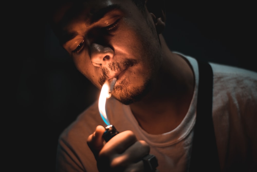 man lighting cigarette