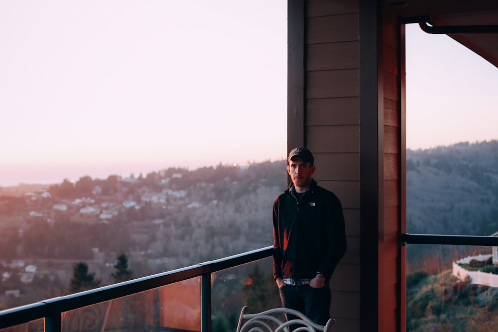 man standing near handrails during daytime