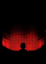 a person standing in front of a red light