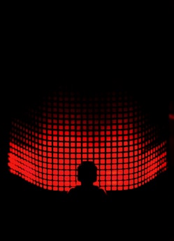 a person standing in front of a red light