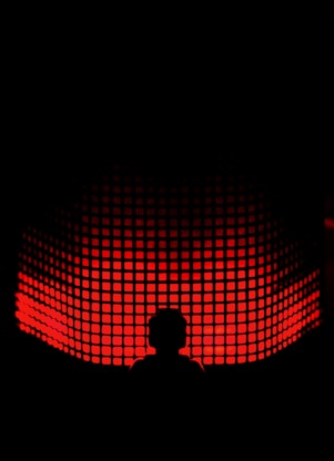 a person standing in front of a red light