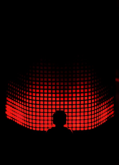 a person standing in front of a red light