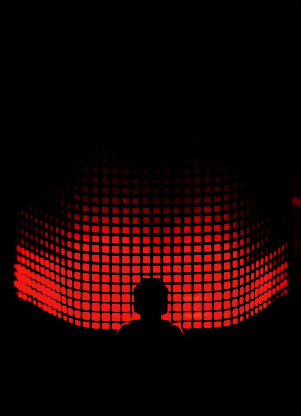 a person standing in front of a red light