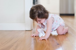 girl crawling on parque floor