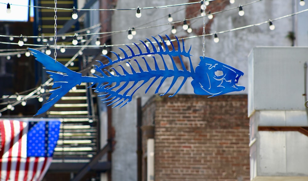 blue plastic fish toy hand