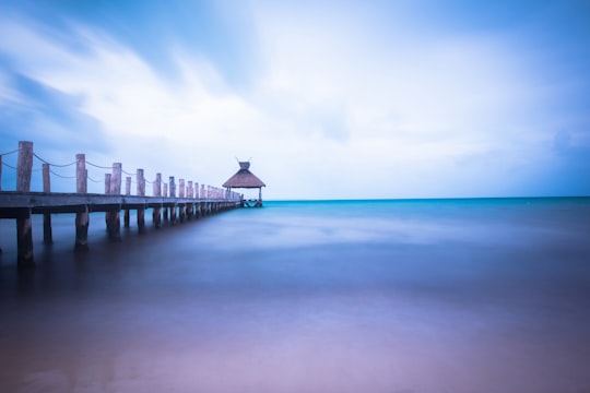 dock on body of water under cloudy sky in Isla Mujeres Mexico