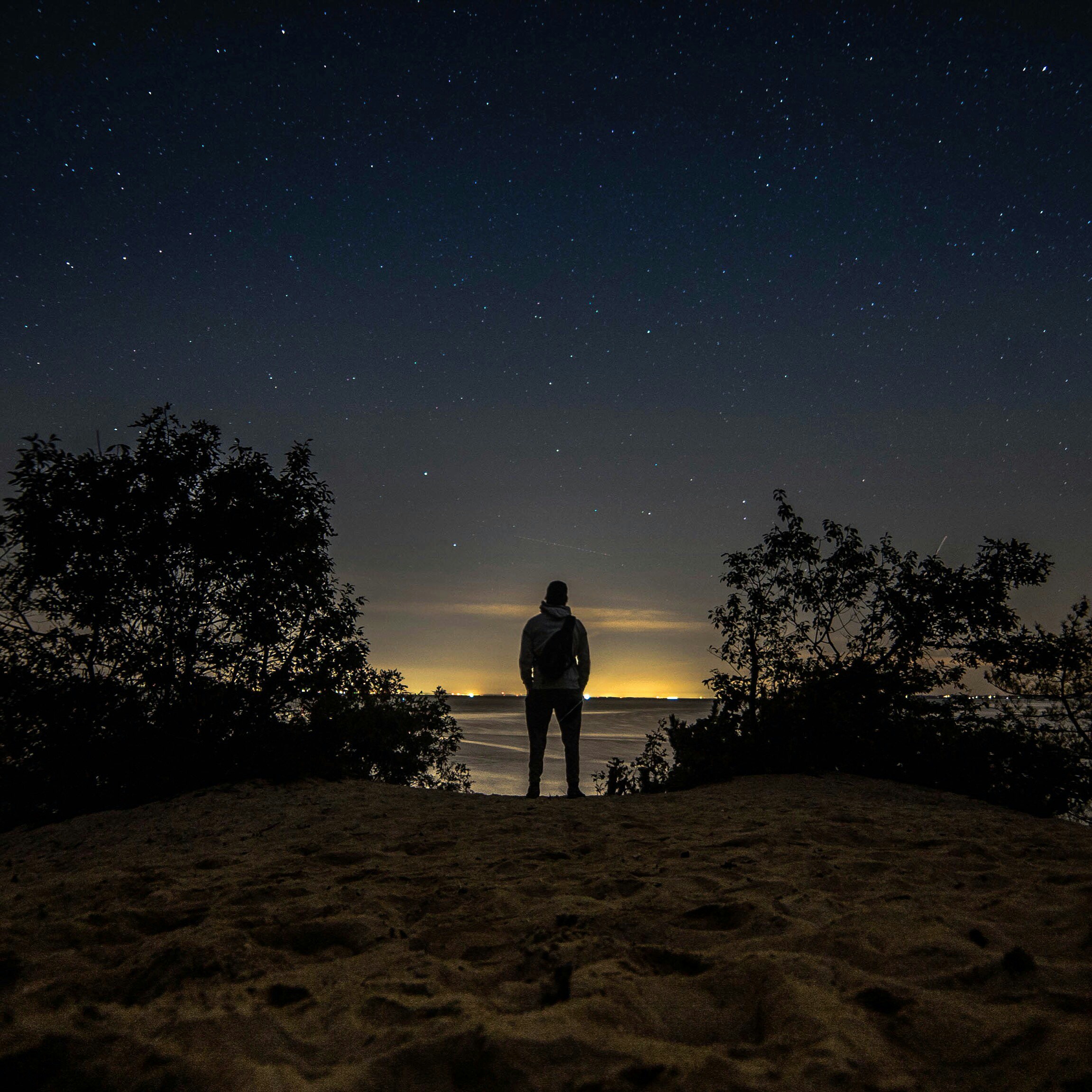 man standing in front of body of water
