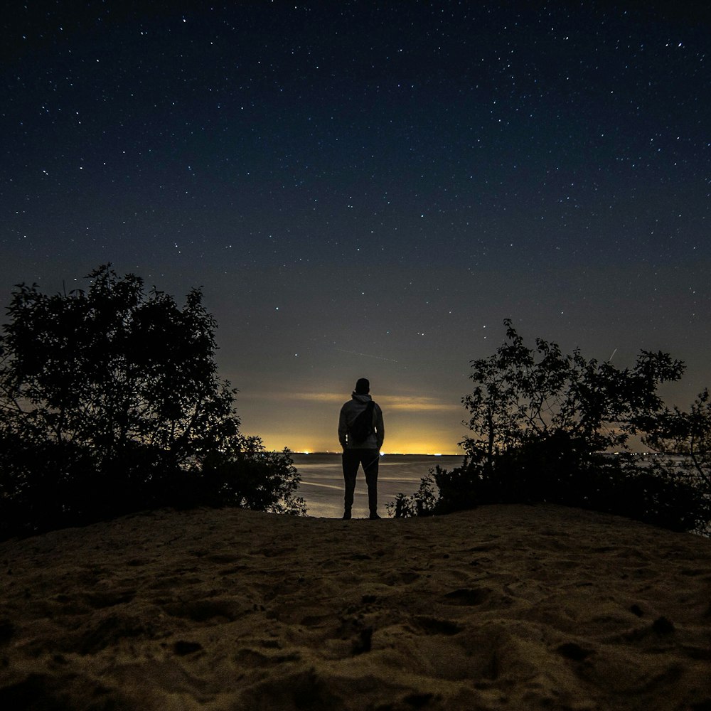 man standing in front of body of water