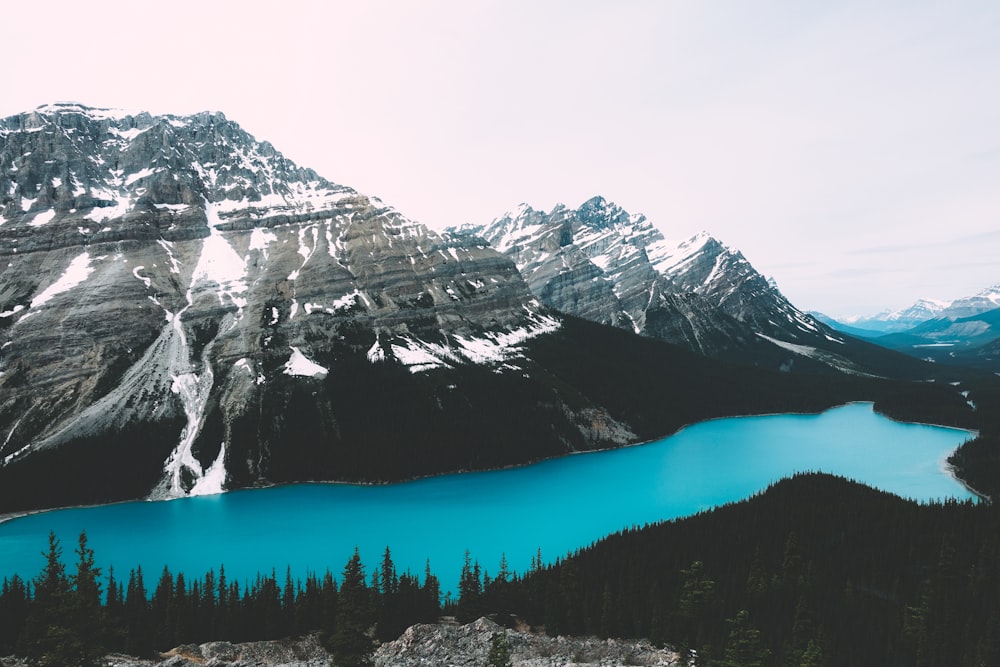 body of water across mountain during daytime