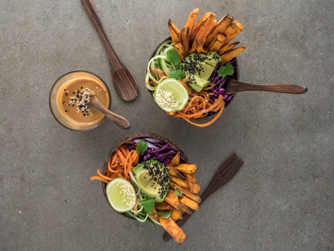 salad on brown wooden bowl with dip, Plant Based asian infused salad