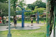 A peaceful outdoor scene with mothers and children playing.