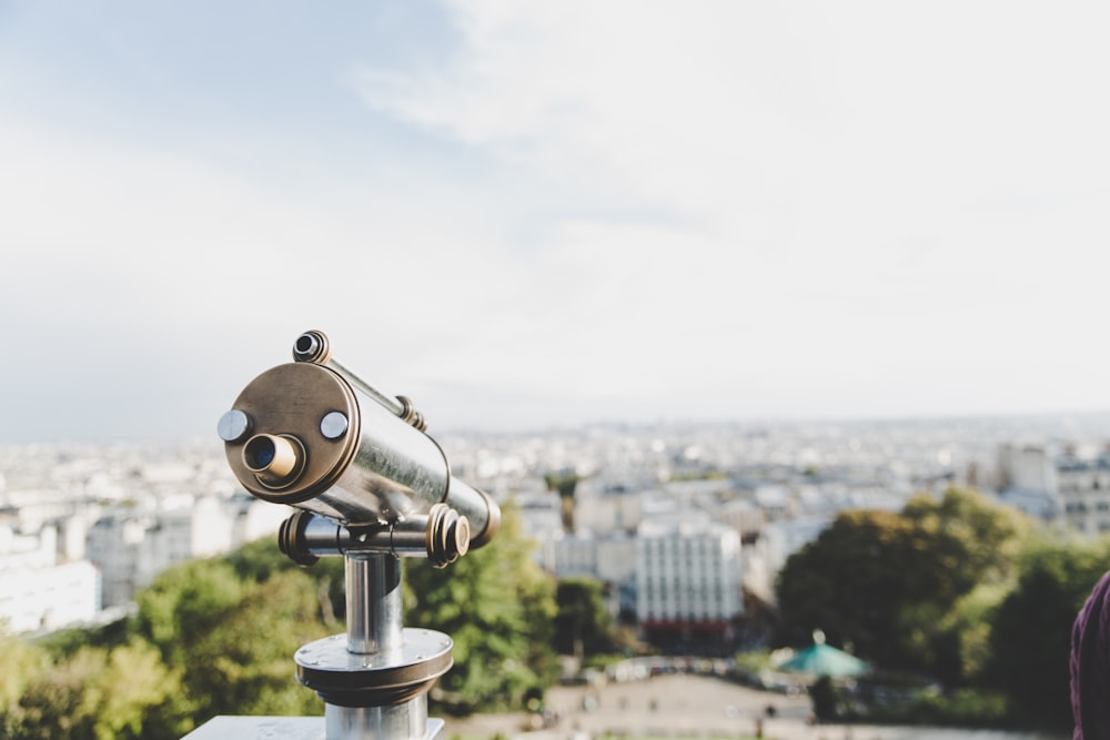 shallow focus photography of coin operated mono-scope under cloudy sky