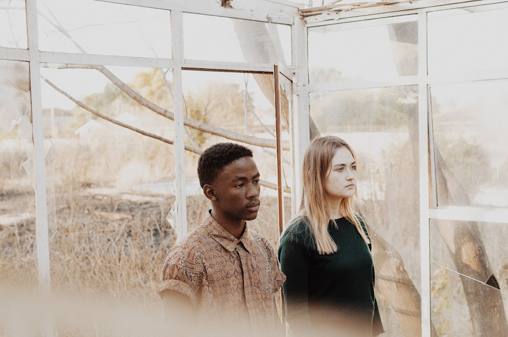 man in brown shirt beside woman in black shirt